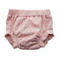 Pink training pants with white daisy  pattern on a white background