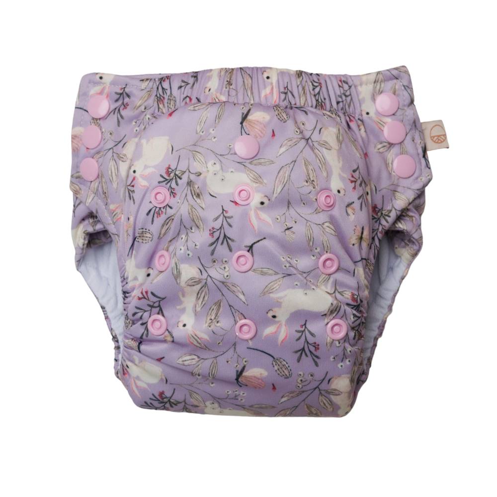 Reusable Nappy pant in purple bunnies design with snaps on a white background