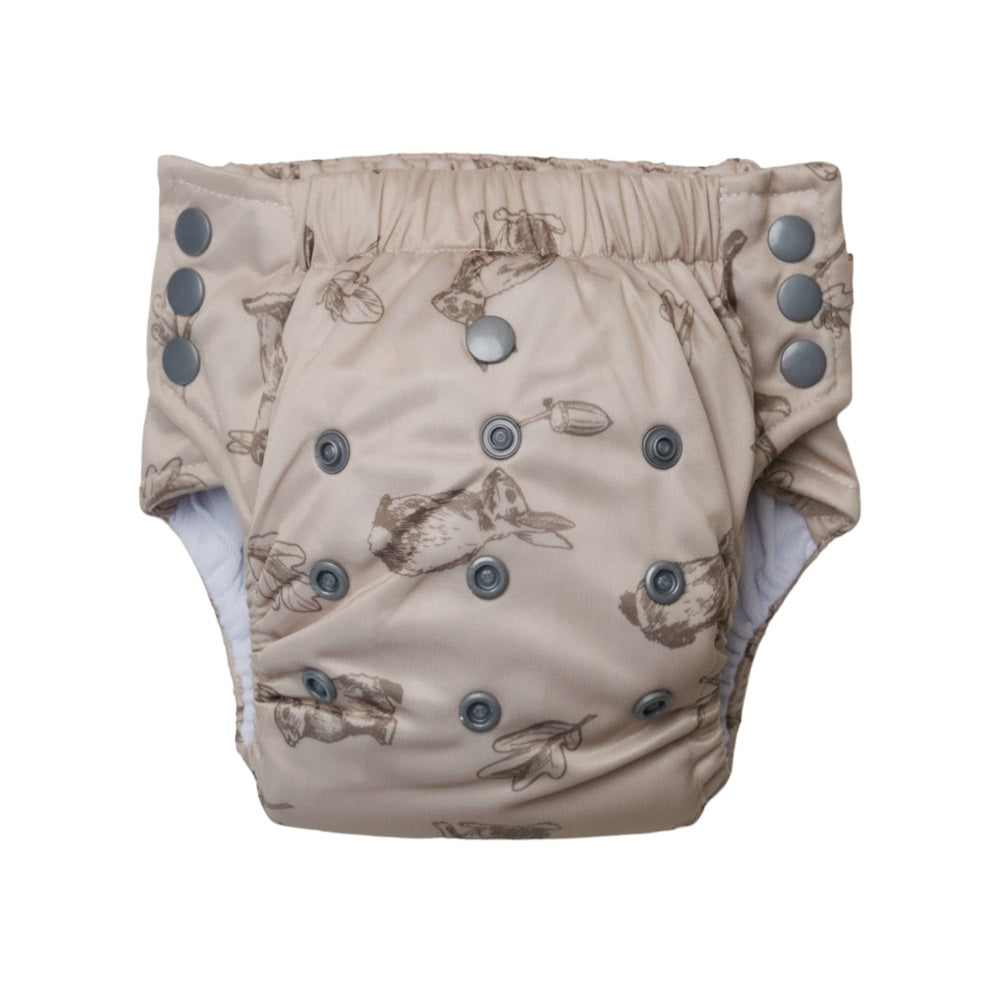 Beige reusable toddler pull-up style nappy with rabbit pattern and gray buttons on a white background