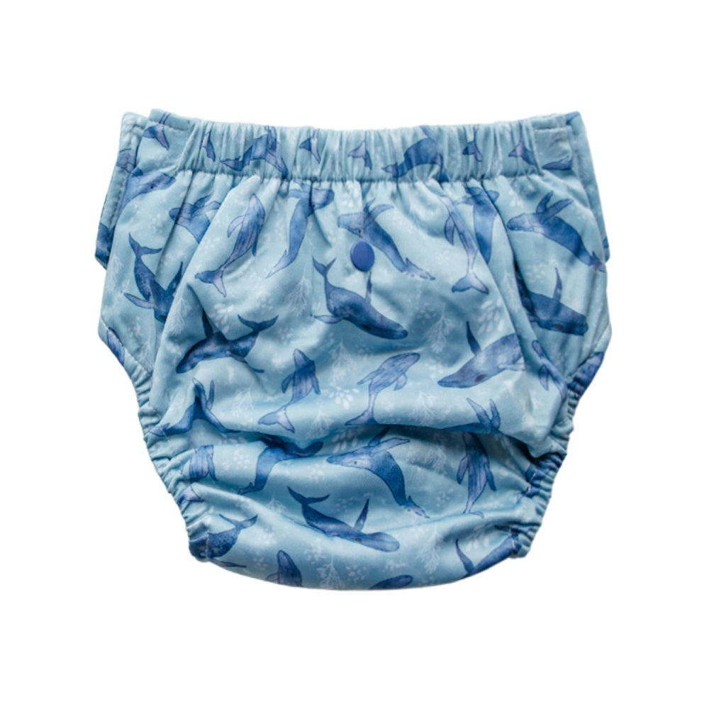 Back view of a blue straight up reusable nappy with whale pattern on a white background