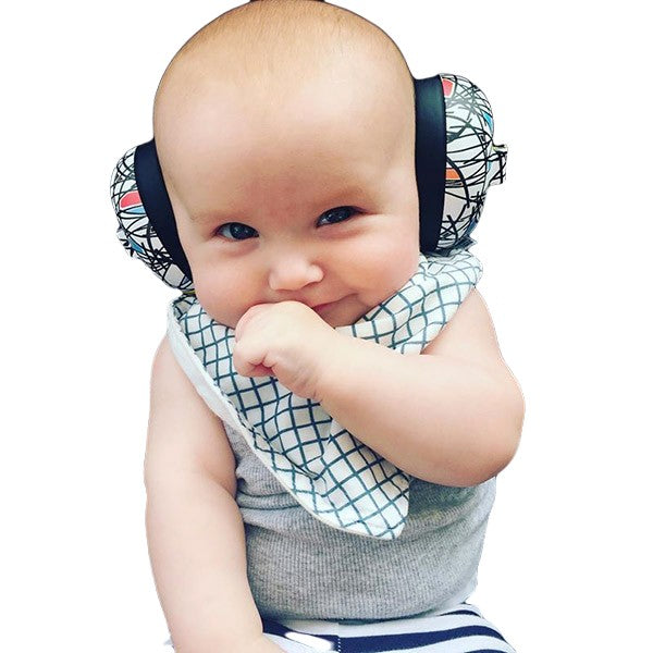 A baby wearing a gray sleeveless top and a white bib with a blue grid pattern, sitting against a plain white background.
