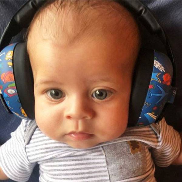 Baby wearing colorful headphones with a blue and red pattern