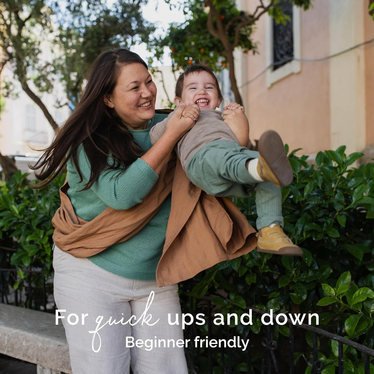 Woman lifting a child outdoors with text 'For quick ups and down Beginner friendly'.