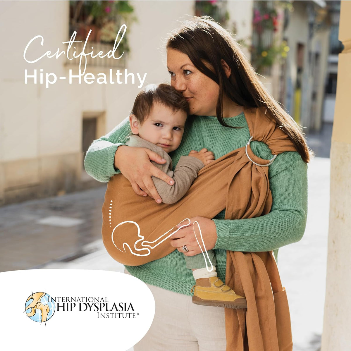 Woman holding a child in a sling with 'Certified Hip-Healthy' text and International Hip Dysplasia Institute logo.