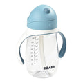 Clear children's sippy cup with blue lid and handle, featuring measurement markings and the Béaba brand name.