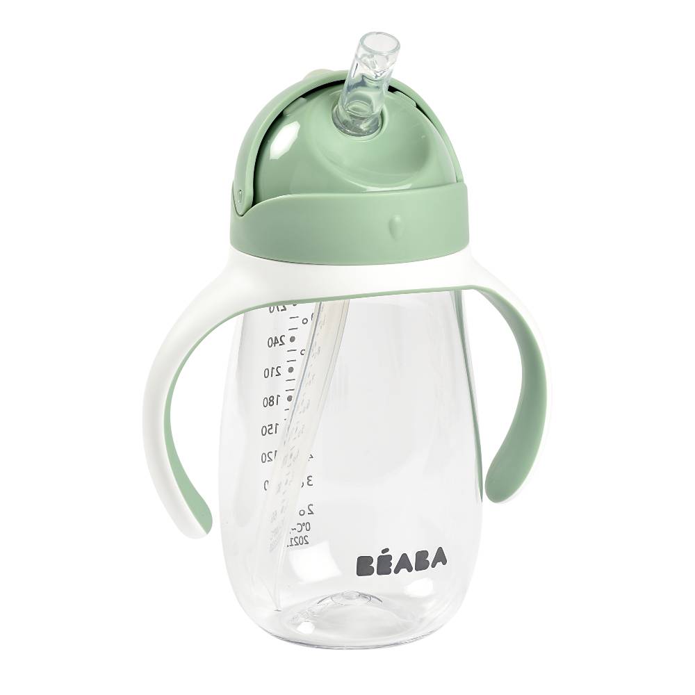 Sippy cup with green lid and handle on a white background