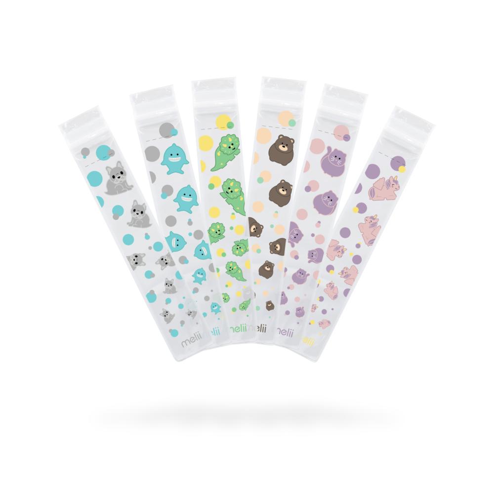 Five clear plastic ice pops moulds with colorful animal patterns on a white background