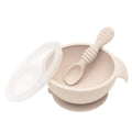 Beige Silicone Feeding Bowl with lid and silicone spoon on a white background