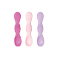 3 silicone spoons in pink and purple on a white background