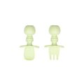 A light sage green set of silicone baby cutlery chewtensils including one spoon and one fork with bumkins logo on the handle
