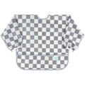 A long sleeve bib with elasticated wrists and front pocket in grey and white check pattern and bumkins tag