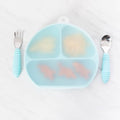A clear stretch silicone lid shown on a blue 3-section silicone grip dish with fork and spoon located on either side on a marble background 