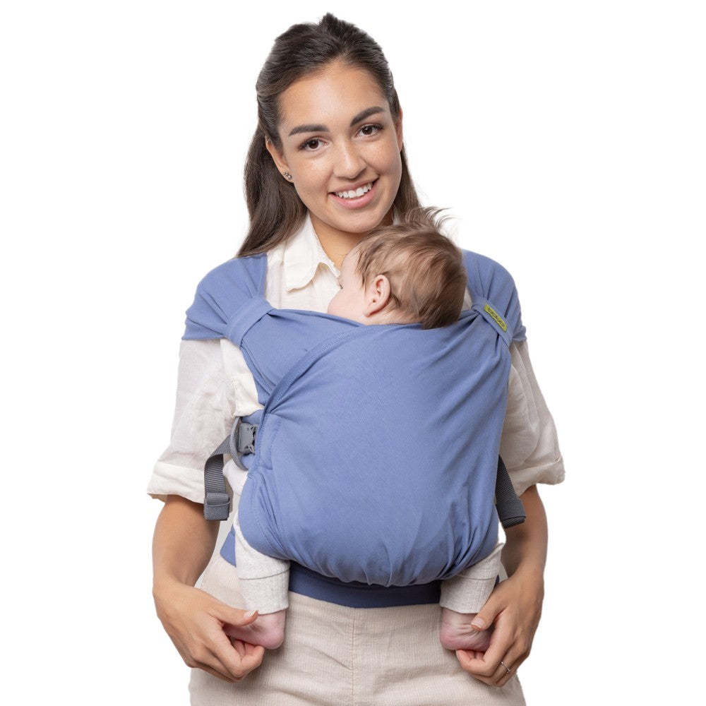 Woman carrying a baby in a blue baby carrier on a white background