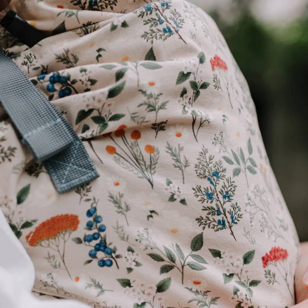 Floral-patterned fabric with a green strap on a blurred background