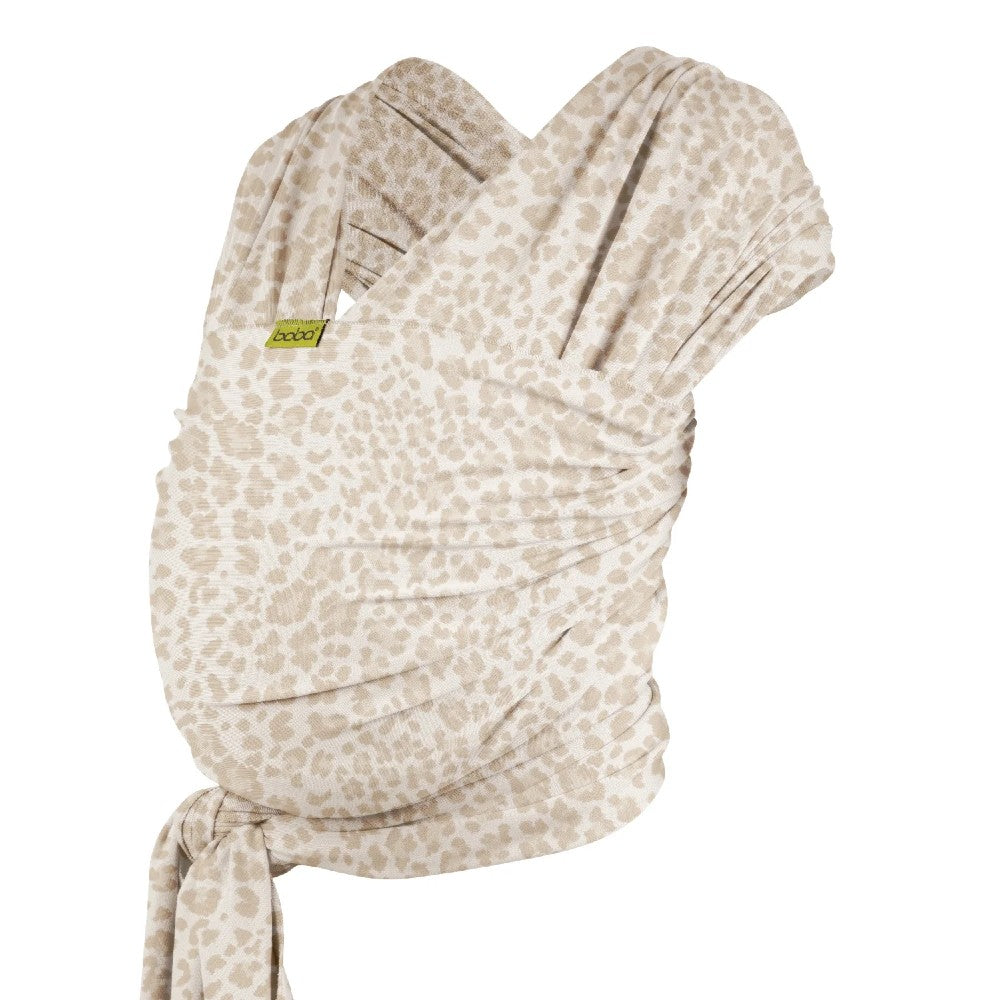 Beige baby carrier with a subtle leopard pattern on a white background