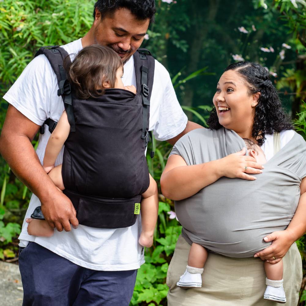 Two adults with children in baby carriers outdoors Boba X and Boba wrap models