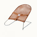 Brown coloured baby bouncer on white background.