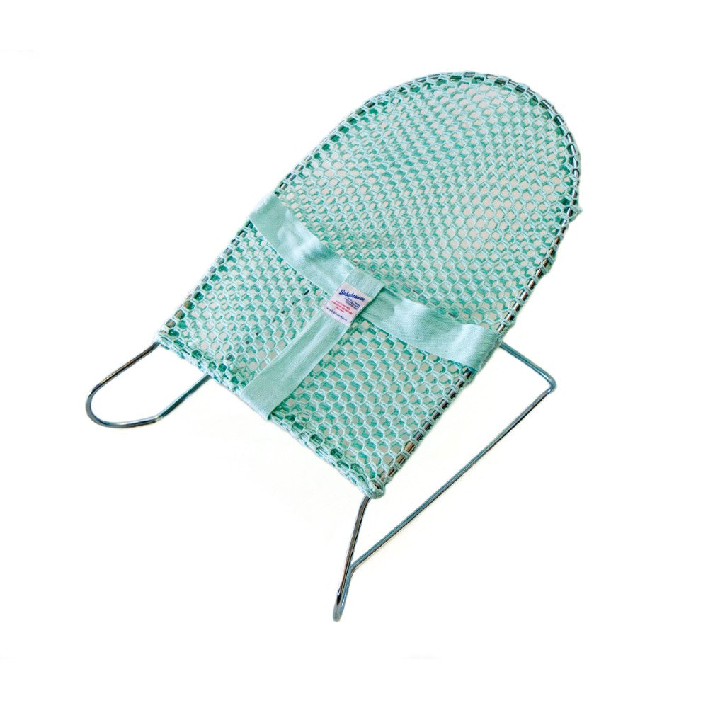 Mint coloured baby bouncer on white background.