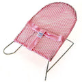 Pink baby bouncer against white background. 