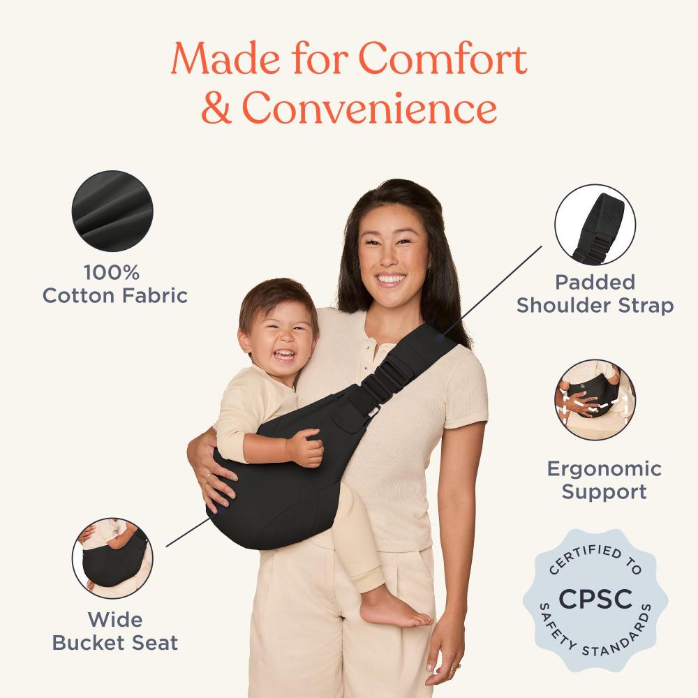 Woman holding a child in a black baby carrier with text highlighting features on a white background