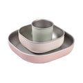 Stainless steel and silicone flatware set in a pink/beige colour against a white background