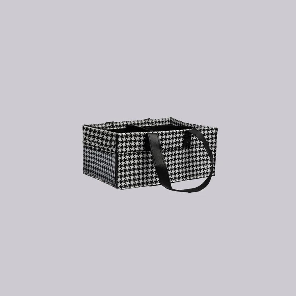 A rectangular storage basket with a black and white houndstooth pattern, featuring two black handles, shown against a solid light gray background.