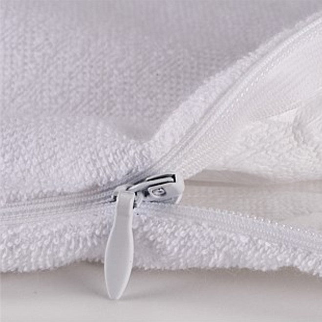 Close-up of a white textured toweling fabric with a white zipper and a white pull tab, showing the material detail.