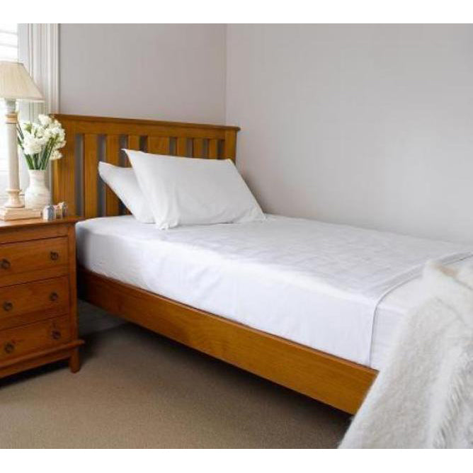 Bedroom with wooden bed frame, white brolly sheet and bedding, and wooden nightstand.
