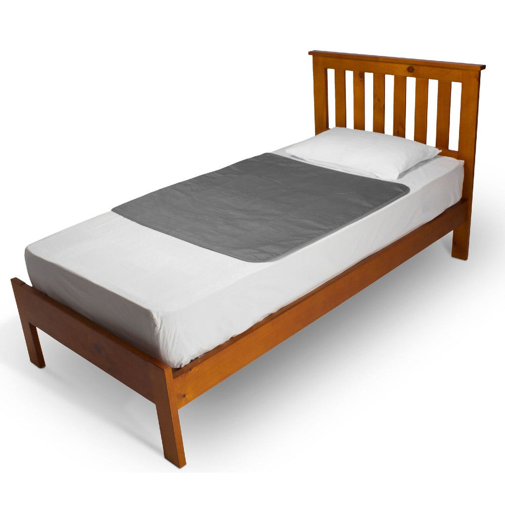 A wooden single bed frame with a slatted headboard shown with white bedding and a grey brolly sheet bed pad on a plain white background.