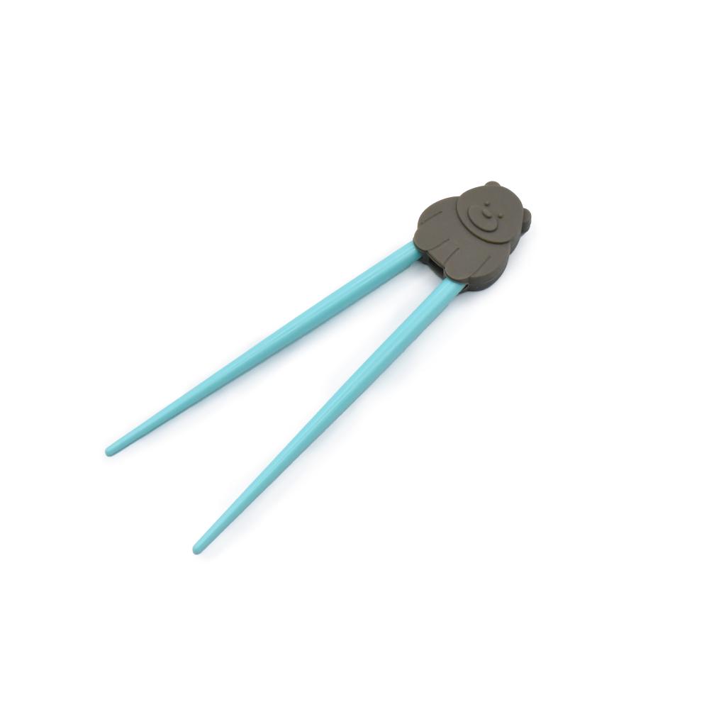 Pair of blue kids trainer chopsticks with a gray handle on a white background