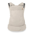 Atoddler and child carrier backpack in a light beige fabric, shown from the back on a clean white background. The carrier features dark gray adjustable shoulder straps and a small tan brand label on the upper right side.