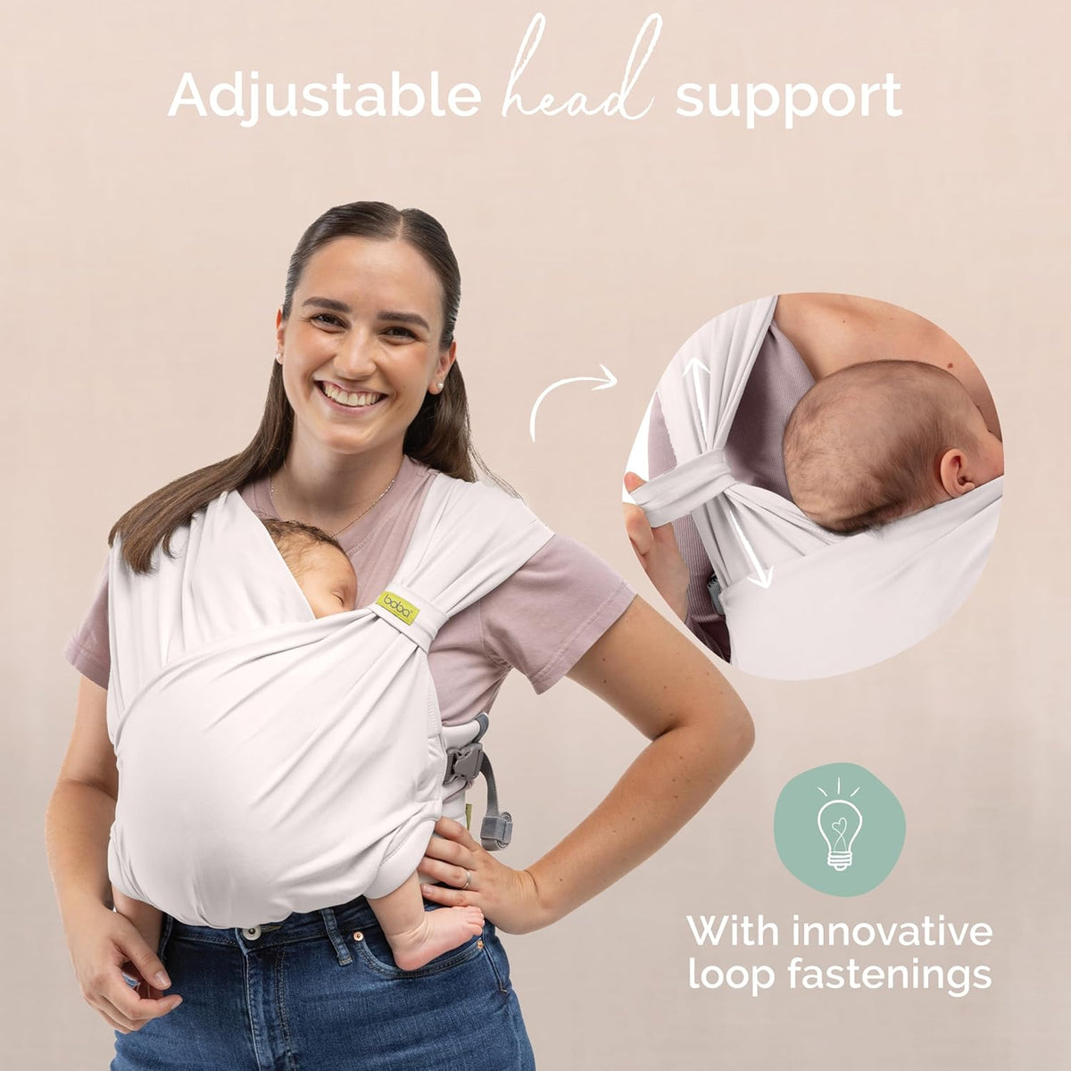 Woman using a baby wrap carrier with adjustable head support and innovative loop fastenings.