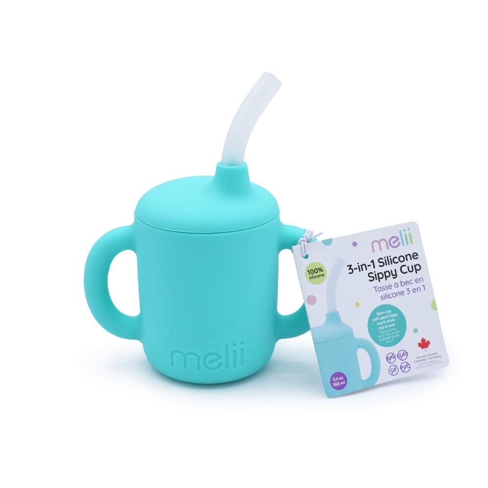 Turquoise silicone sippy cup with straw and packaging on a white background