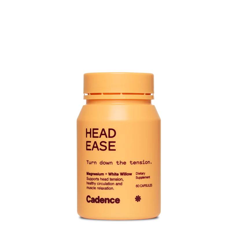 An orange cylindrical supplement bottle labeled 'HEAD EASE' by Cadence, photographed on a clean white background.