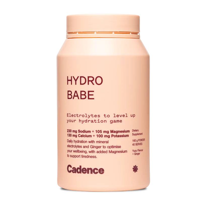 A peach-colored bottle of Cadence Hydro Babe electrolyte powder supplement on a solid white background.
