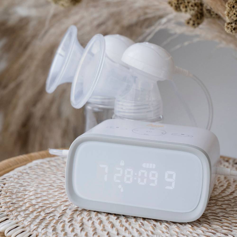 Double electric breast pump with digital display on a woven surface