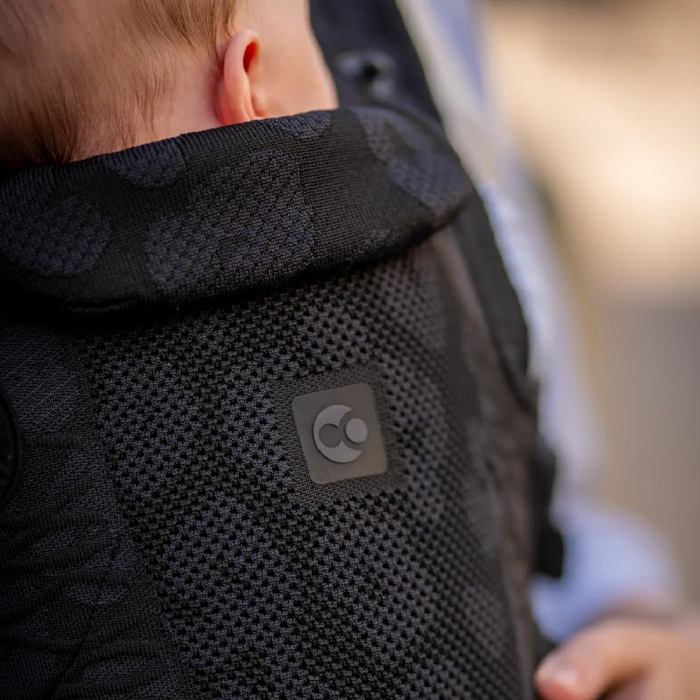 Close-up of a black carrier with a brand logo on a blurred background