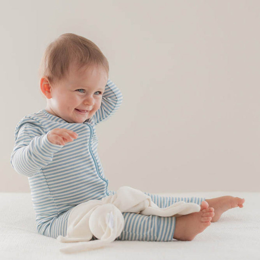 Sitting infant with Cream Cuskiboo comforter on lap