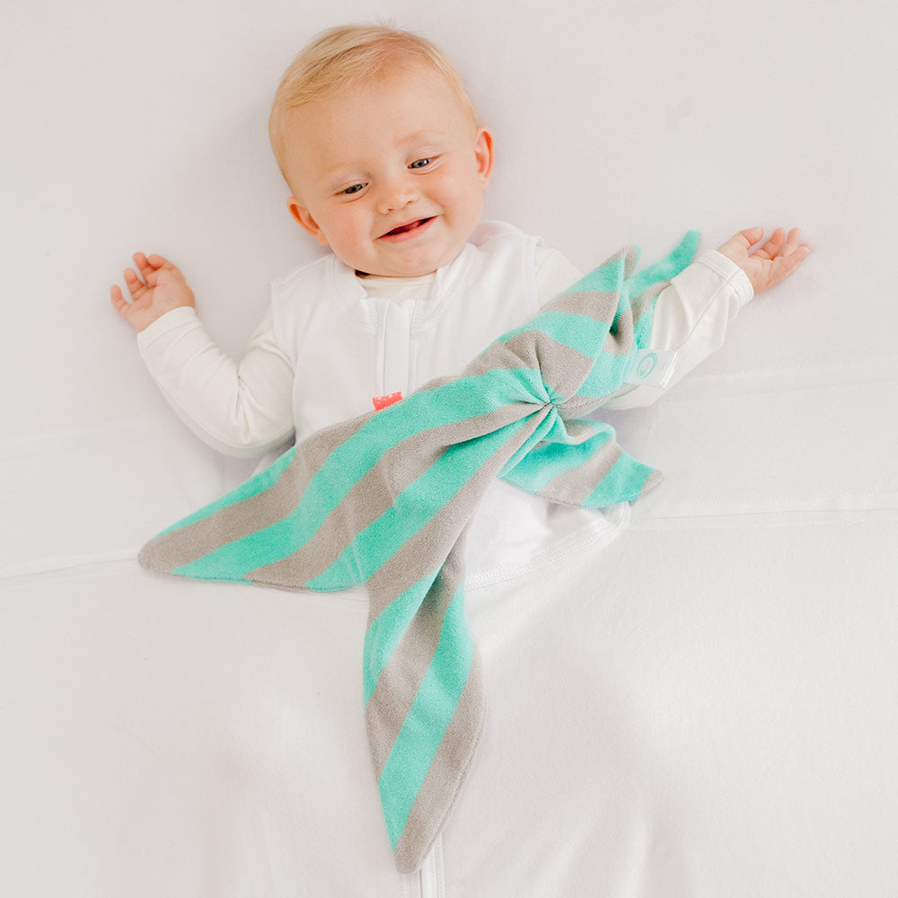 Infant with a Mint and Grey striped Fabby Cuski Comforter on a white background