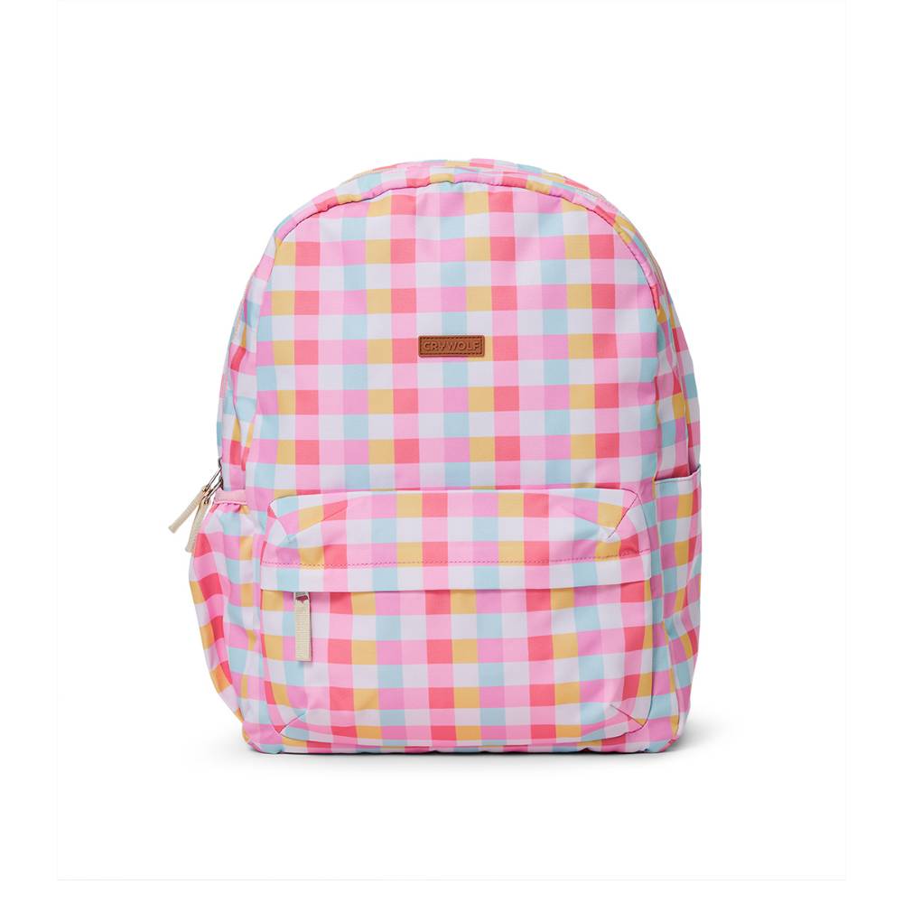 A backpack with a pastel pink, yellow, and light blue gingham check pattern, featuring a small brown leather brand patch on the front.