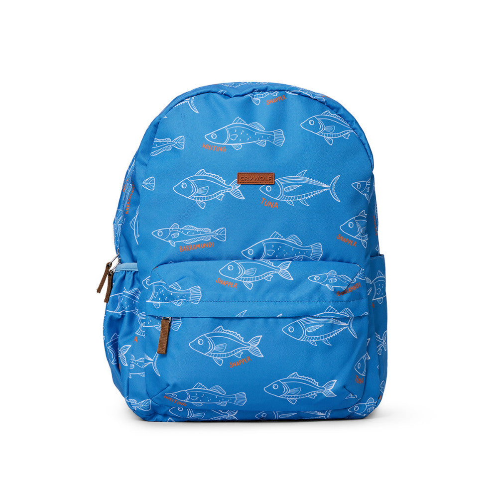 A blue backpack featuring an all-over pattern of white and orange fish illustrations, shown against a plain white background.