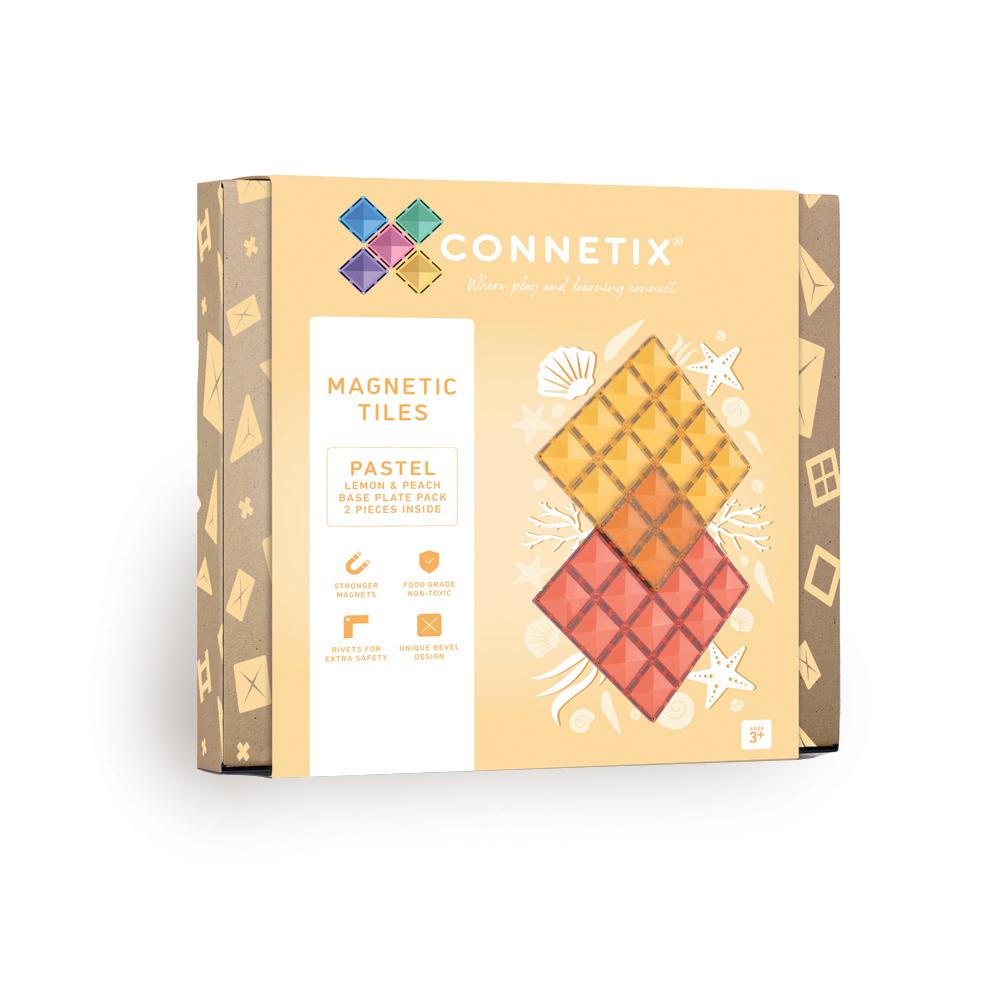 Box of Connetix magnetic tiles with pastel color scheme on a beige background