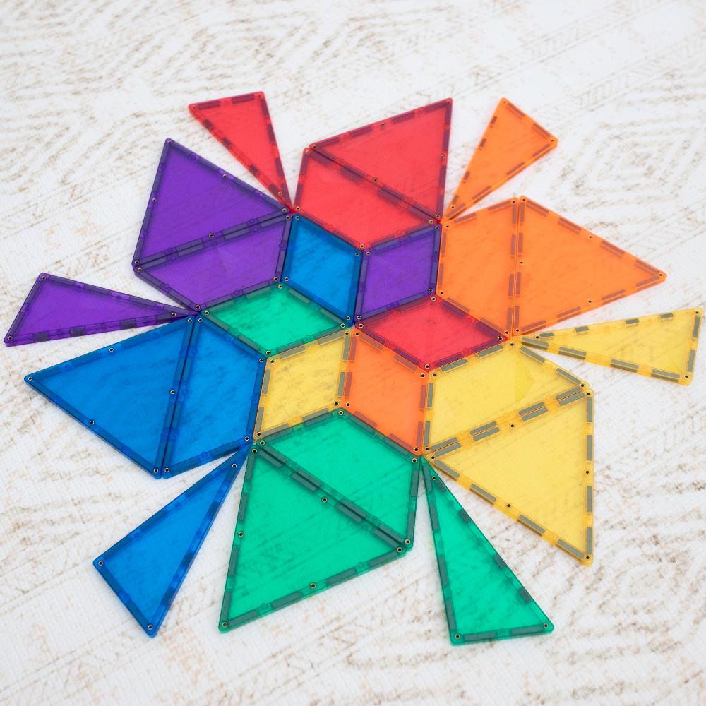 Colorful magnetic building blocks arranged in a circular pattern on a textured surface.