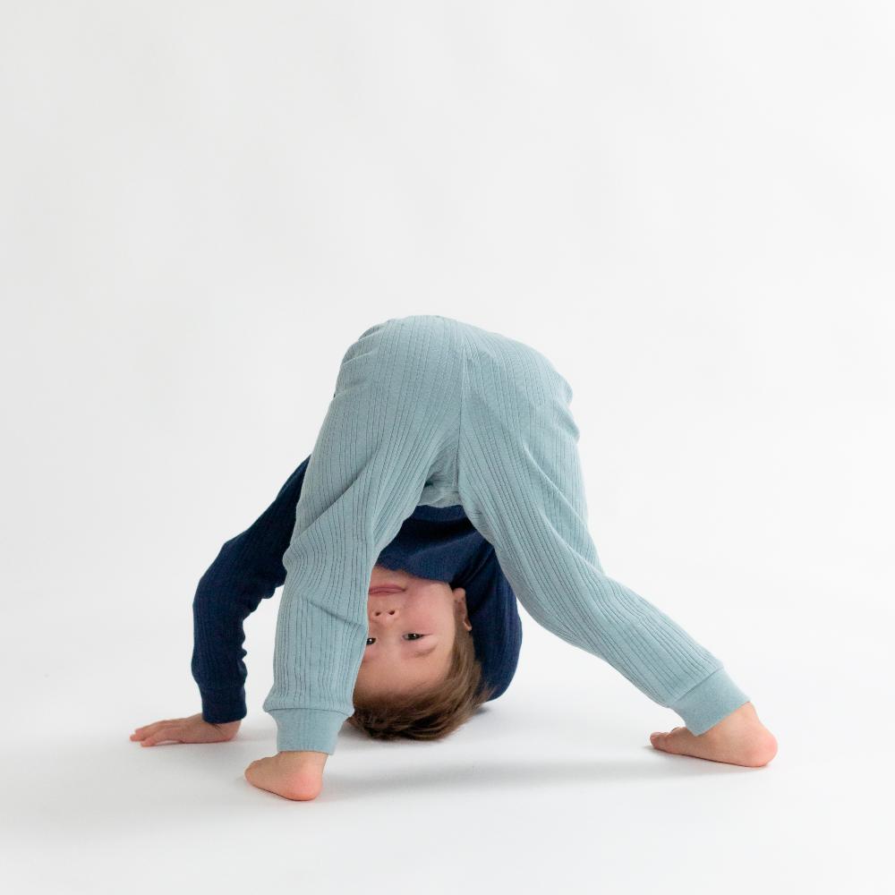 Child wearing a blue outfit with a hood on a white background