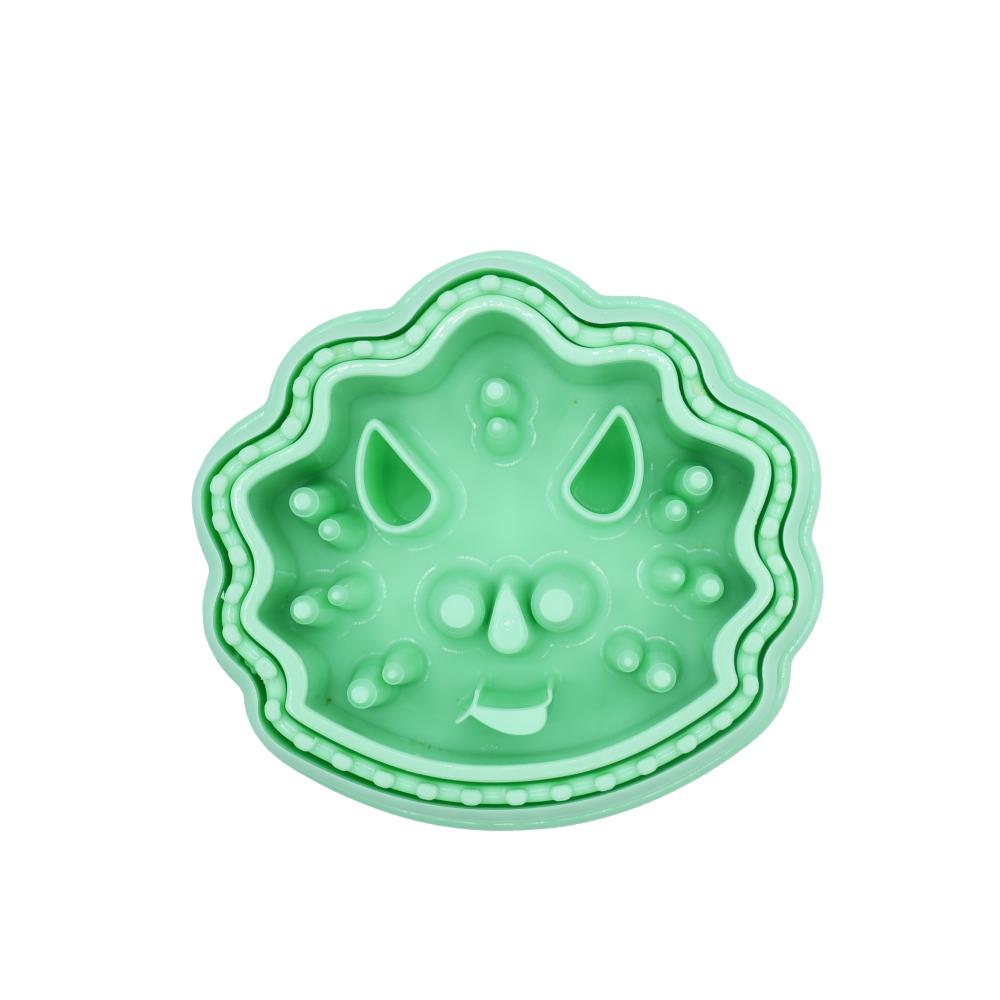 Green silicone mold with a dinosaur design on a white background