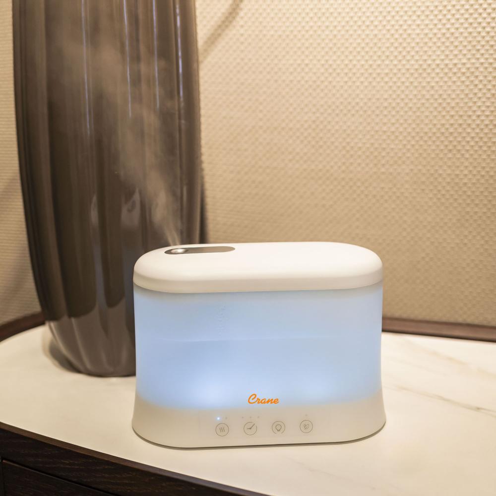 Humidifier emitting steam on a surface with a neutral background