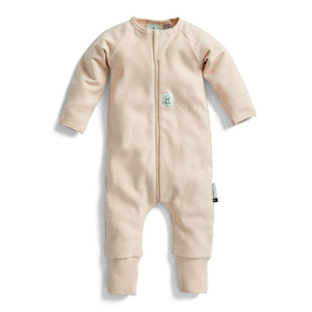 Beige baby onesie with a zipper on a white background