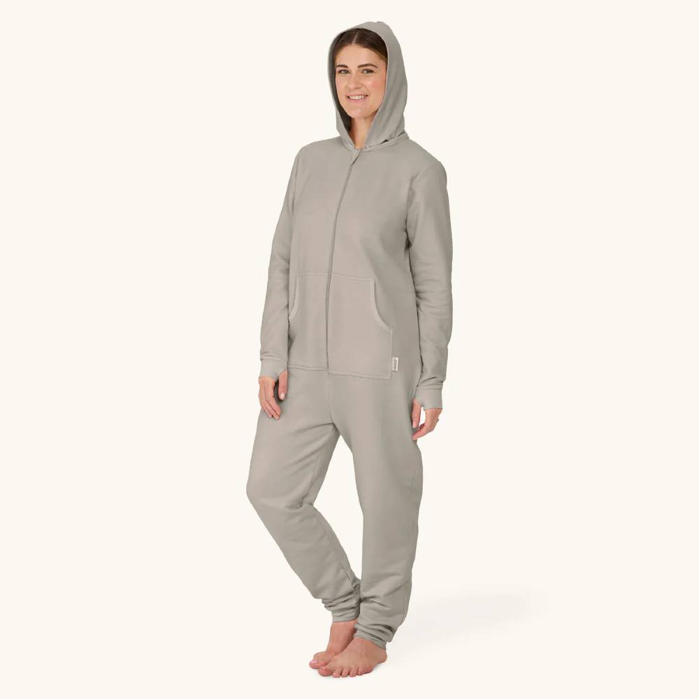 Person wearing a gray onesie on a white background