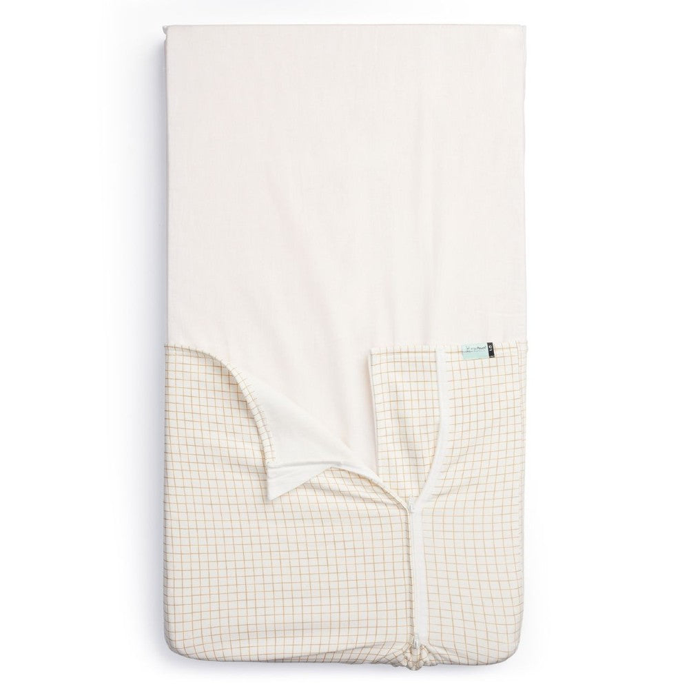 HugMe Blanket in Caramel grid pattern on a mattress on white background