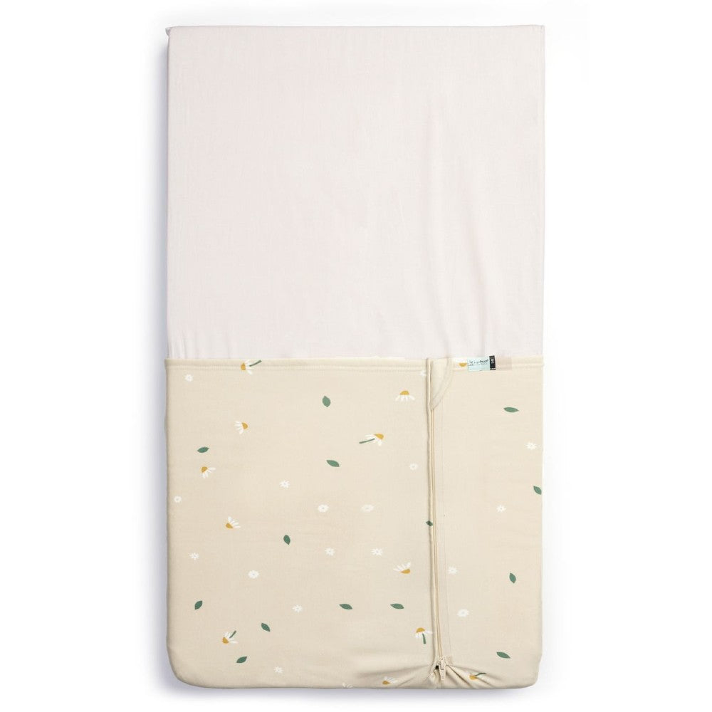 HugMe Blanket in Daisy Sprinkle pattern on a mattress on white background